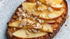 an apple toast on a plate with the words how to make upside down apple tahini toast