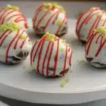 a white plate topped with cake balls covered in frosting