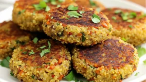 crab cakes with cream cheese and spinach quinoa in the middle on a wooden cutting board