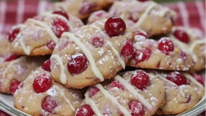 a white plate topped with cookies covered in powdered sugar on top of a table