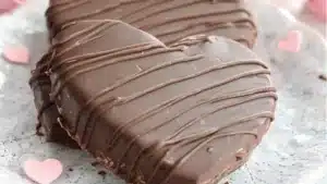 homemade reese's valentine's hearts with chocolate in the middle and peanut butter on top