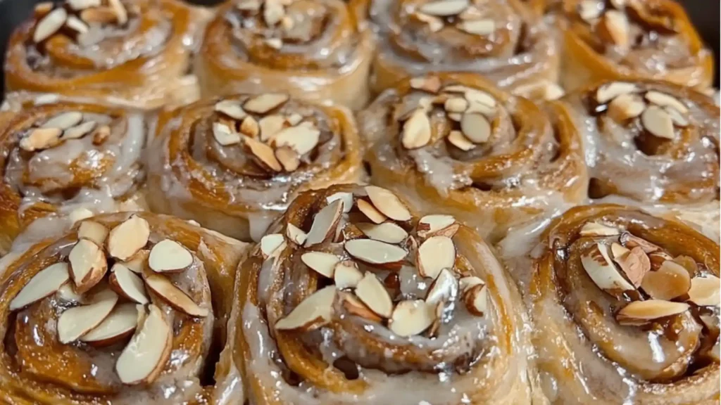 an almond sweet roll is shown in a white dish with the words gooey on it