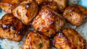 crispy honey garlic salmon bites with white rice and chopsticks