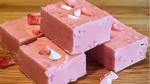 two ingredient strawberry fudge cake with pink frosting and sprinkles