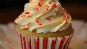 cupcakes with white chocolate frosting and sprinkles on a plate
