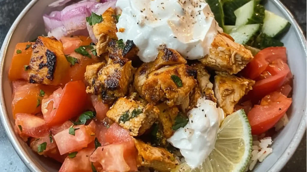 Greek Chicken Bowls with fresh veggies and homemade tzatziki. These gluten-free high-protein bowls are perfect for clean eating dinner ideas and healthy veggie prep.