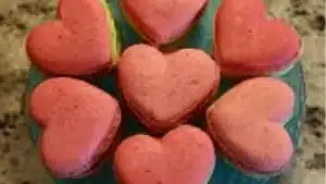 heart shaped red macaroons on a wooden table