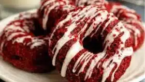 red velvet donuts with white frosting and sprinkles on top are ready to be eaten