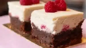 raspberry cheesecake brownies are stacked on top of each other
