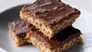 A golden brown baked Mac and Cheese Meatloaf Casserole showing creamy macaroni nestled next to moist meatloaf. This ultimate comfort food mashup makes a fantastic family meal.